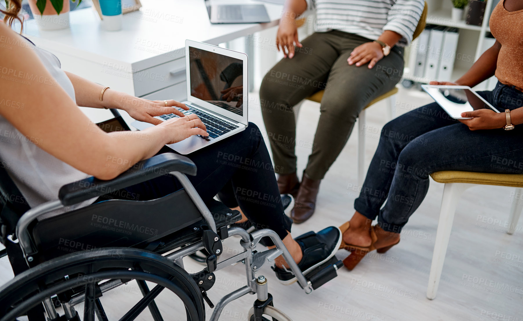 Buy stock photo Shot of a businesswoman with disabilities working with colleagues in a modern office