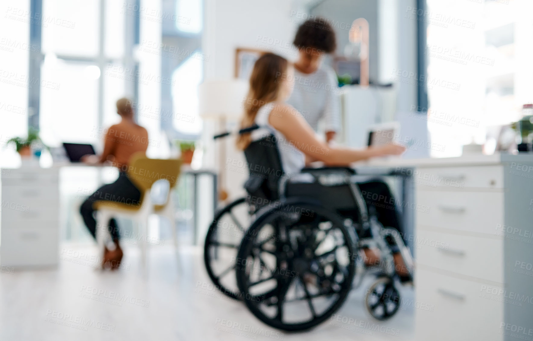 Buy stock photo Shot of a businesswoman with disabilities working with colleagues in a modern office