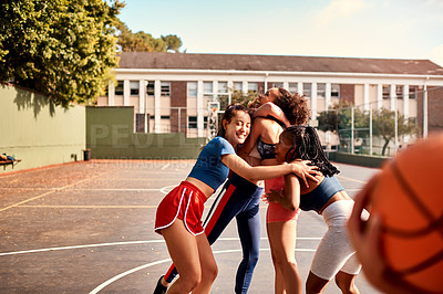 Buy stock photo Cropped shot of a diverse group of sportwomen celebrating their win together after playing basketball