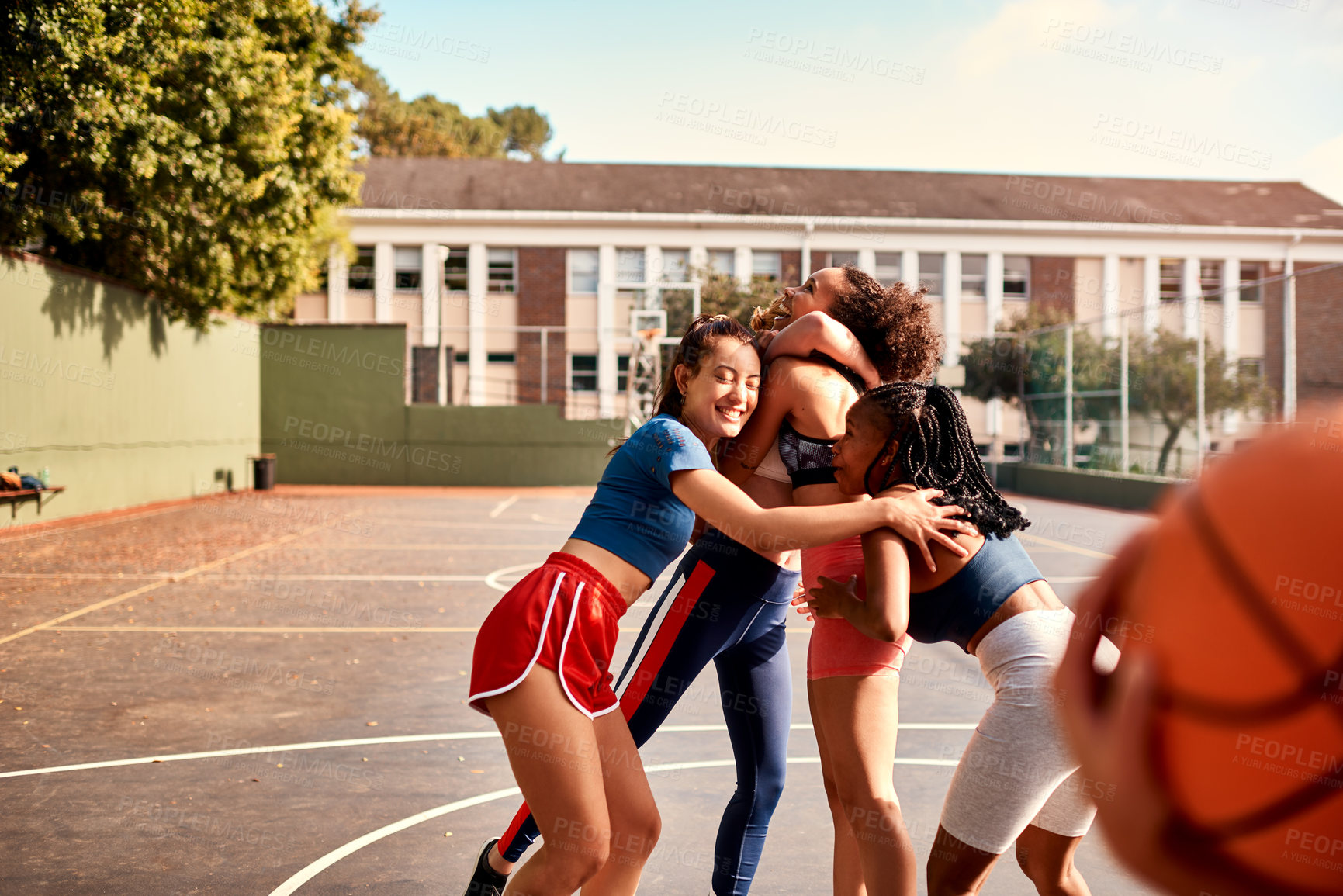 Buy stock photo Basketball, game and outdoor hug with people, fitness and group diversity for celebration. High school team, girls and court for sport practice or embrace at match, training and athletes for win