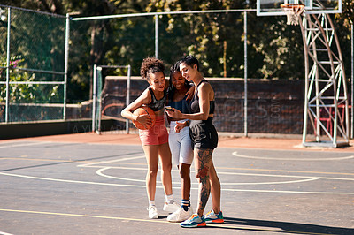 Buy stock photo Basketball, happy friends and girls with phone for sports results, social media or show message online. Mobile, ball and group of women outdoor on training break, fitness and team exercise on court