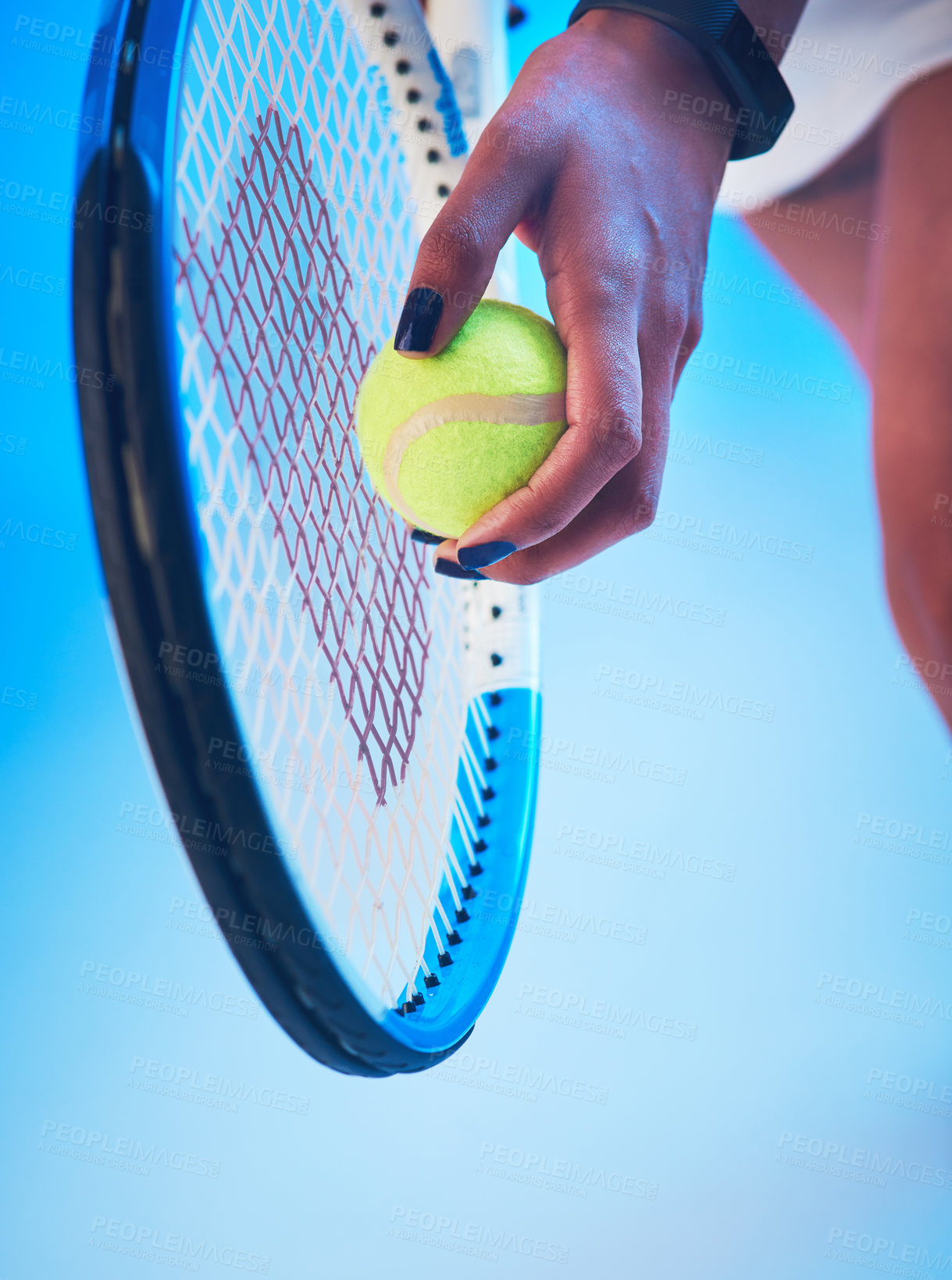 Buy stock photo Cropped shot of an unrecognizable young female tennis player getting ready to serve against a blue background