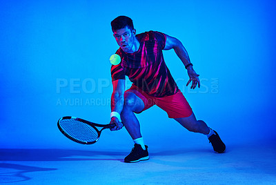 Buy stock photo Blue filtered shot of a tennis player in the studio