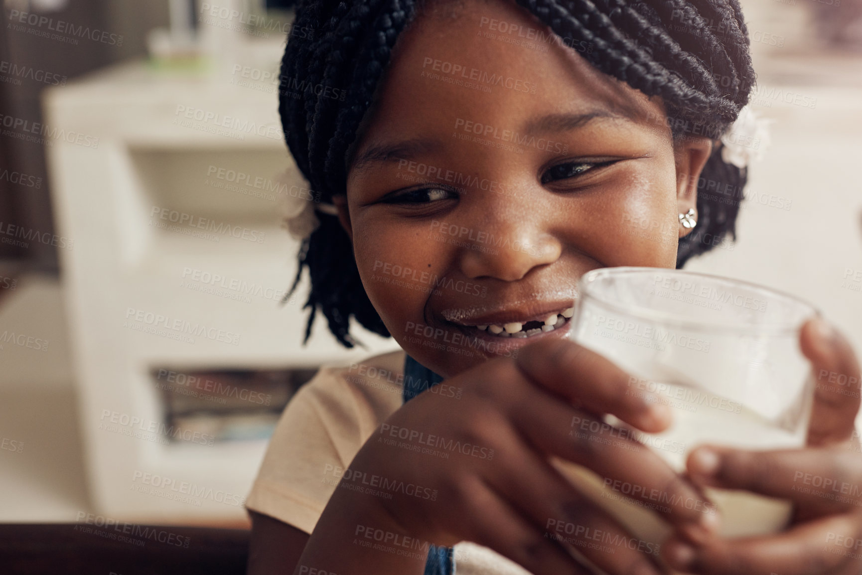 Buy stock photo Cropped shot of an adorable little girl drinking a glass of milk at home