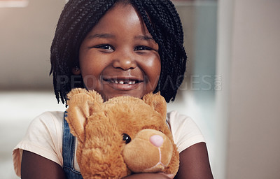 Buy stock photo Smile, portrait and girl in home with teddy bear, hug and playful with toy with happiness. Black child, comfort and companion with stuffed animal for childhood, sentimental value and friends in house