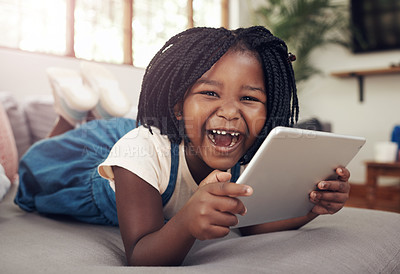 Buy stock photo Portrait, black child and tablet on sofa for game, relax and streaming cartoon in living room. Young girl, connection or tech in house for elearning, education and reading ebook on app online in home