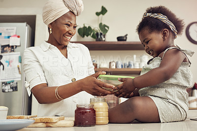 Buy stock photo Portrait of an adorable baby girl helping her mother prepare a lunch meal in the kitchen at home