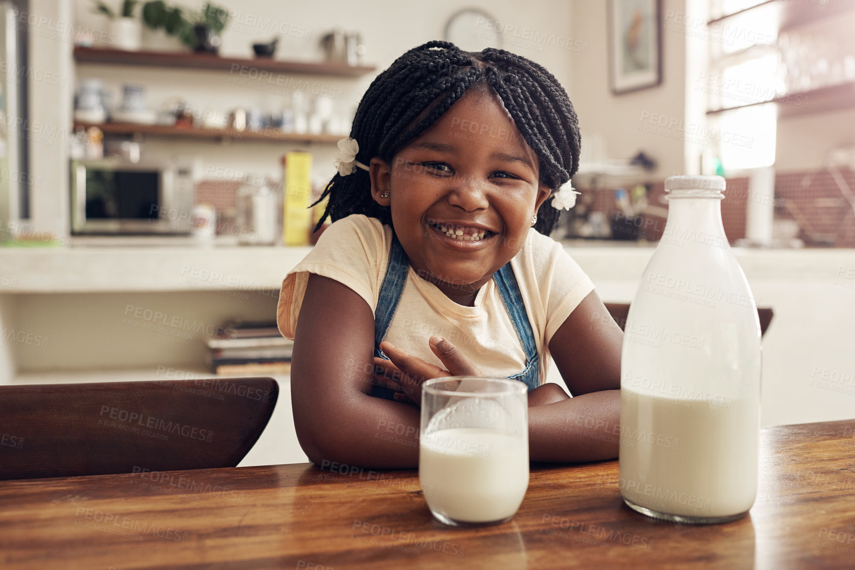 Buy stock photo Portrait of an adorable little girl drinking milk in the kitchen at home