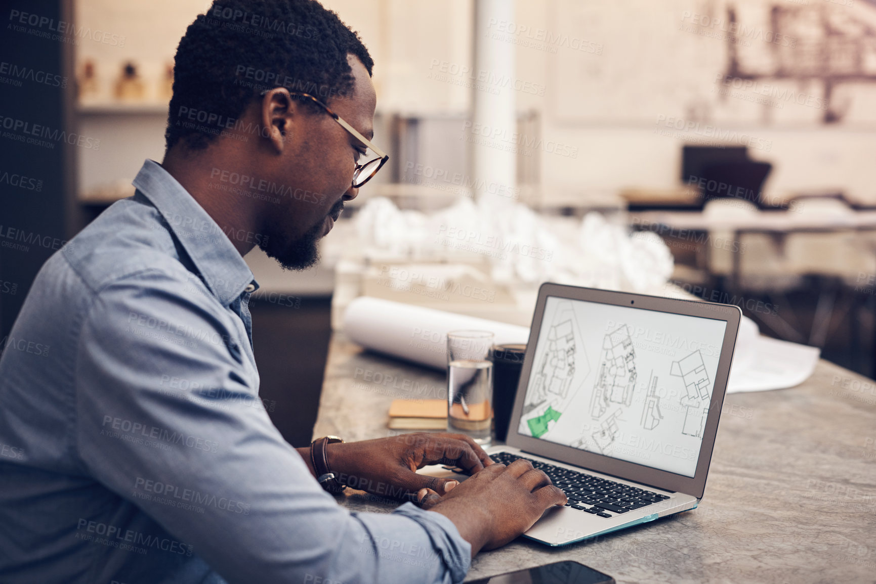 Buy stock photo Architect, office and black man with laptop at desk for property development, research or planning. Contractor, screen and person with technology for digital blueprint, review or brainstorming