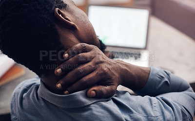 Buy stock photo Cropped shot of a handsome young male architect suffering with neck pain while working in a modern office