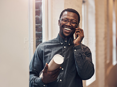 Buy stock photo Cropped shot of a handsome young male architect taking a phonecall while standing in a modern office