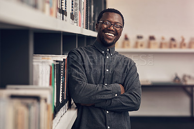 Buy stock photo Cropped portrait of a handsome young male architect smiling while standing with his arms crossed in a modern office