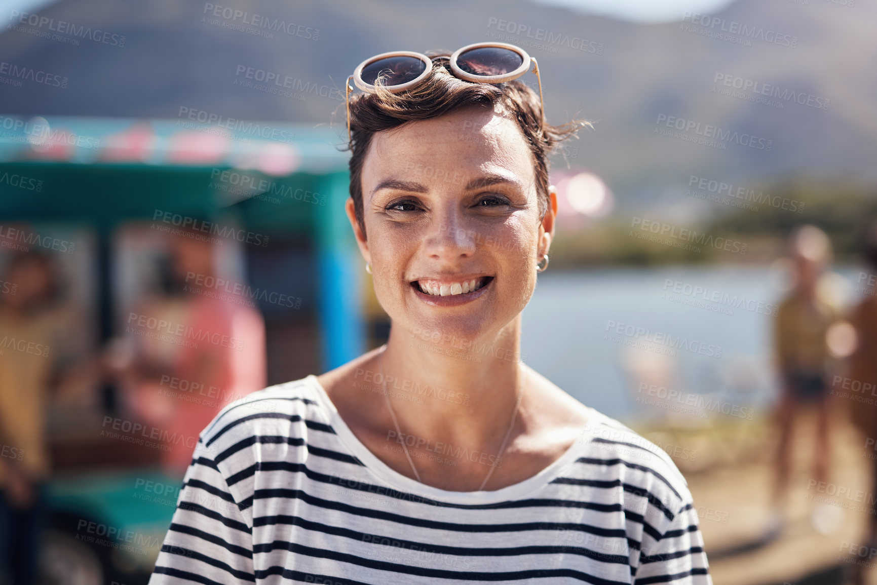 Buy stock photo Woman, portrait and smile by lake for vacation in nature, freedom or adventure travel for wellness. Female tourist, outdoor and relax on holiday with happiness in Canada, sunshine for health by cafe