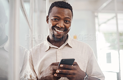 Buy stock photo Portrait of a young businessman using a cellphone in an office