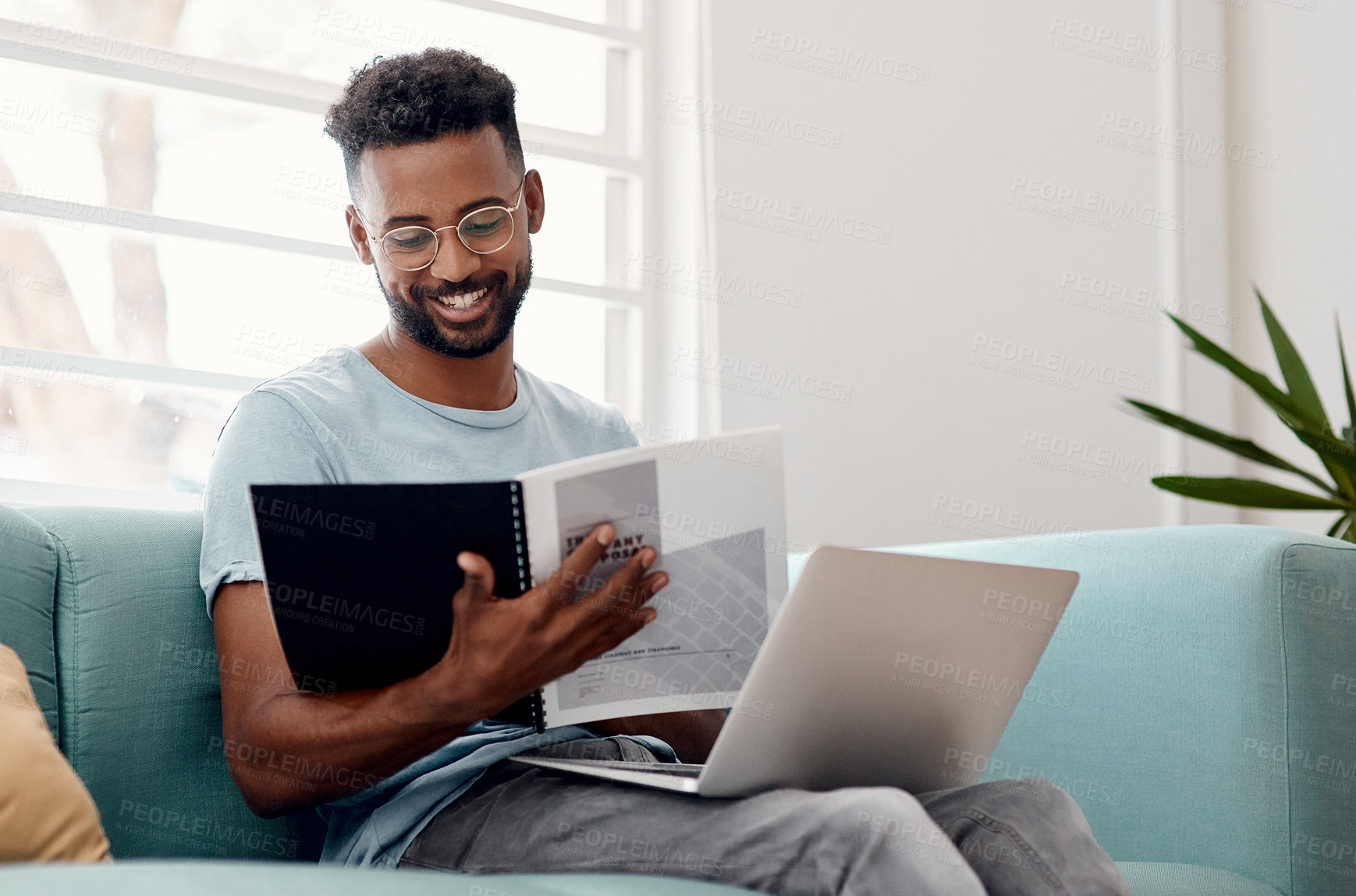 Buy stock photo Remote work, black man and reading document in home for good news, deal and learning information. Paperwork, laptop and happy freelancer on sofa or salesman with files for budget report on internet