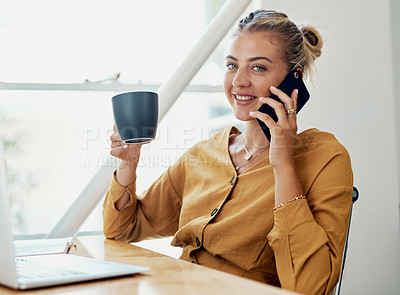 Buy stock photo Cropped portrait of an attractive young businesswoman sitting alone and holding a cup of coffee while using her cellphone