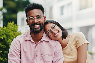 Buy stock photo Cropped portrait of two young businesspeople sitting close together while outside during the day