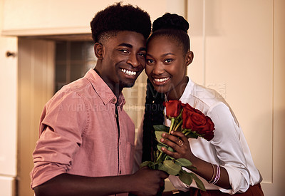 Buy stock photo Cropped portrait of an affectionate young couple smiling while holding a bunch of roses  at home
