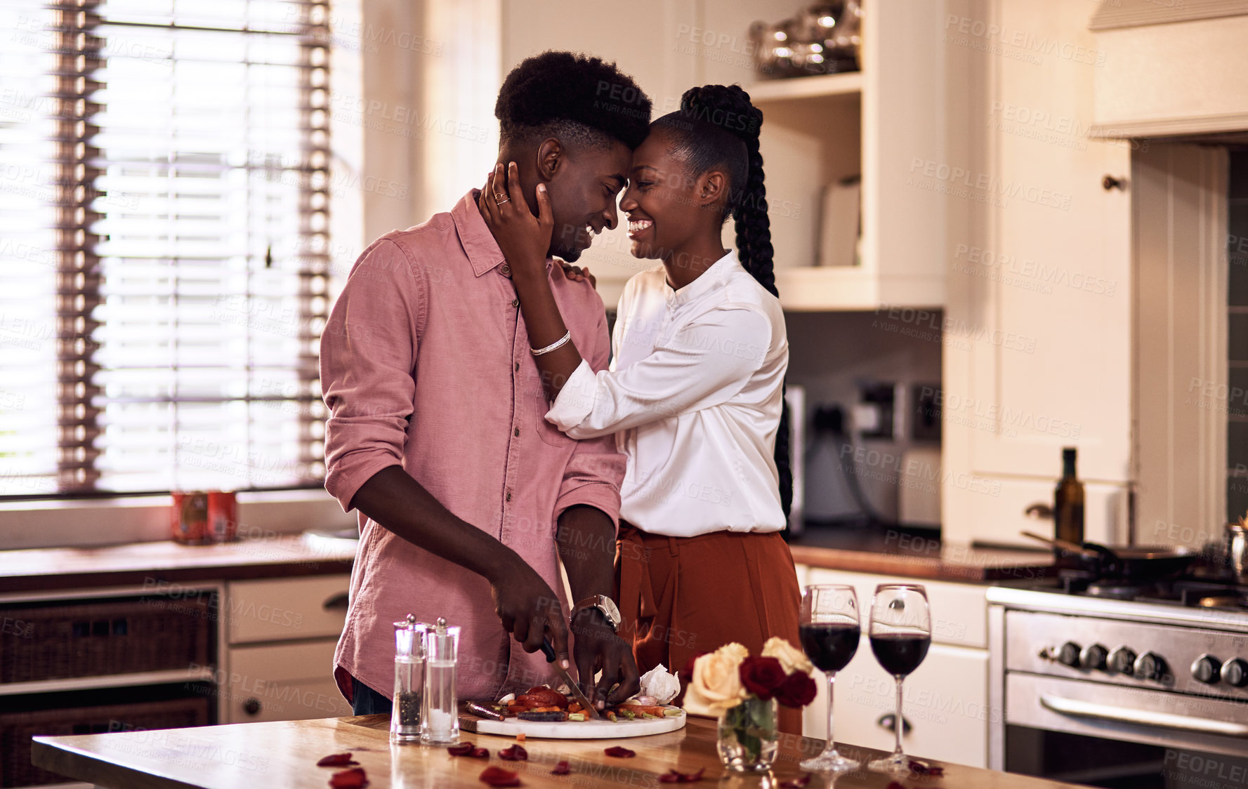 Buy stock photo Kitchen, black couple and forehead touch with wine glass in cooking dinner for support, bonding and roses. Home, relationship and people for anniversary celebration, relax and romantic with meal