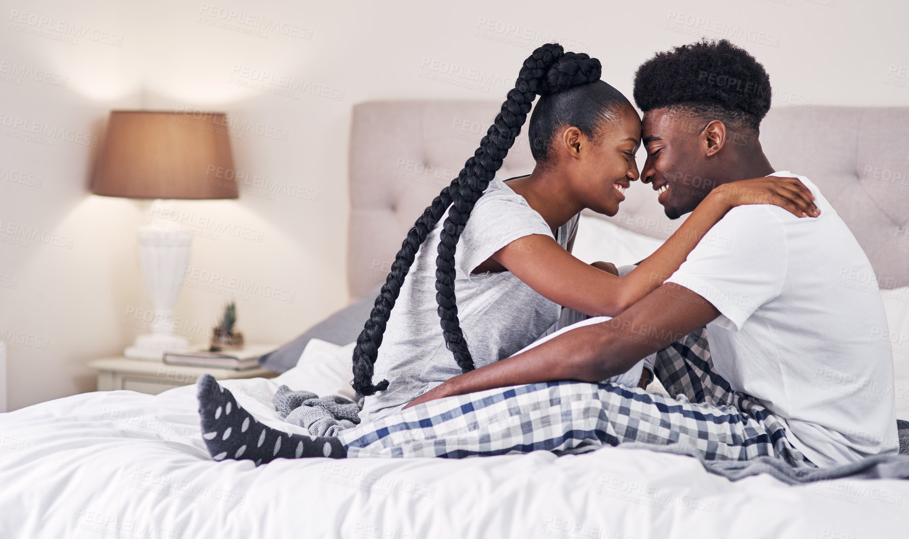 Buy stock photo Bedroom, hug and black couple with love, morning and relax with break, comfort and romance. Anniversary, man and woman in house, embrace and relationship with trust, care and marriage with happiness