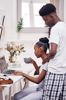 Buy stock photo Shot of a young man interrupting his girlfriend while  working on her laptop at home