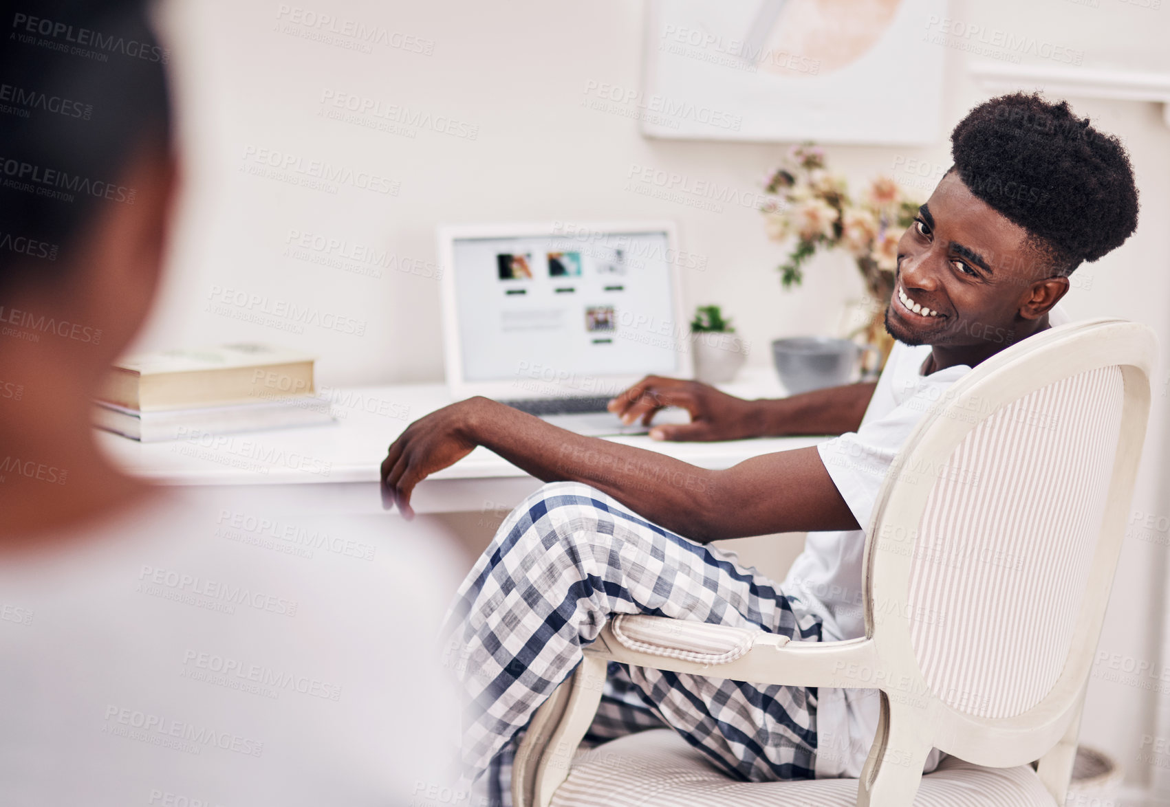 Buy stock photo Defocused shot of a young man using a laptop at home