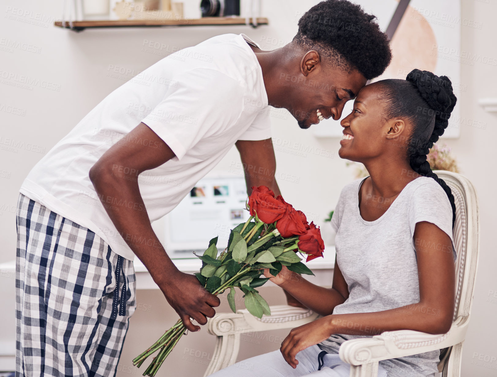 Buy stock photo Happy, roses and black couple with gift in home for anniversary or valentines day celebration. Love, connection and African man and woman hugging with flowers for romantic gift together at house.