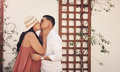 Buy stock photo Cropped shot of a young couple kissing while out on a date