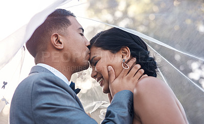 Buy stock photo Shot of a young man kissing his bride on her forehead