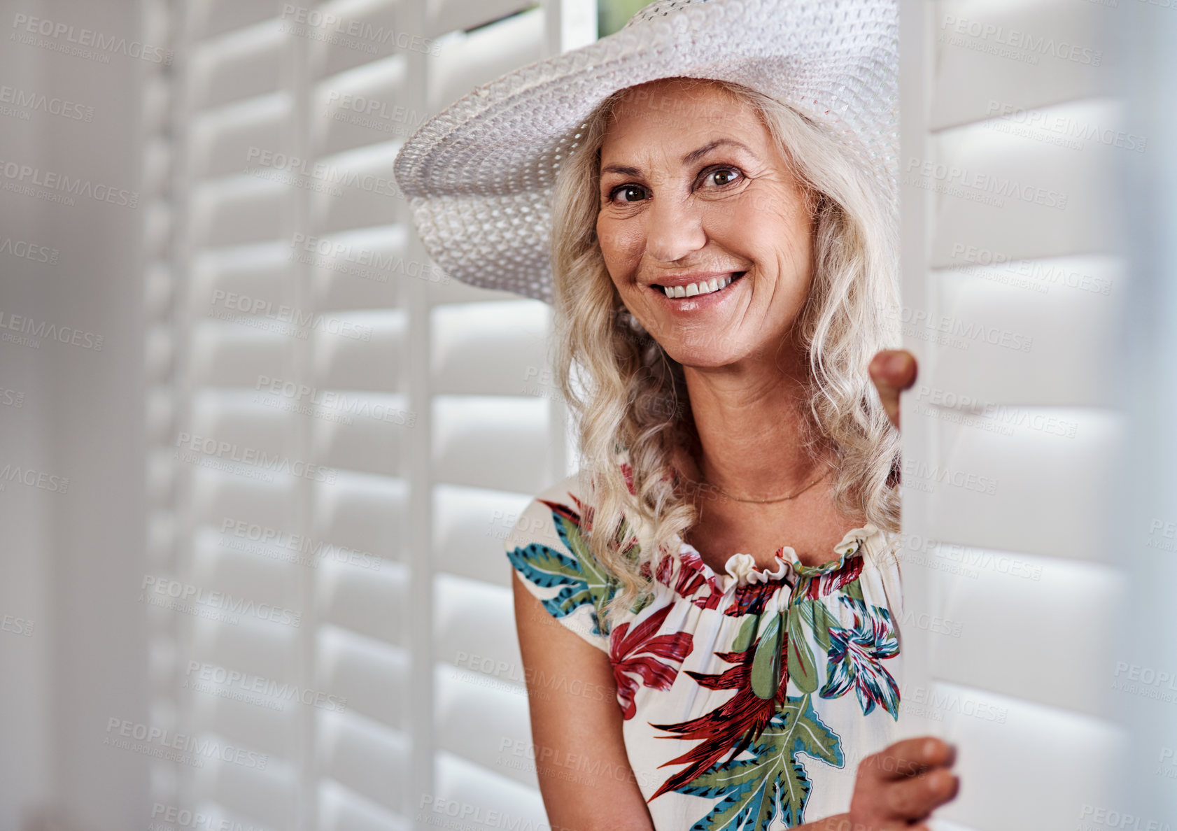 Buy stock photo Cropped portrait of an attractive senior woman smiling while standing indoors on a summer's day