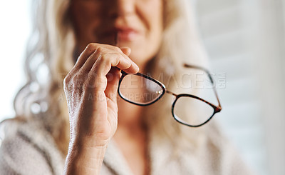 Buy stock photo Cropped shot of an unrecognizable senior businesswoman holding her spectacles at home