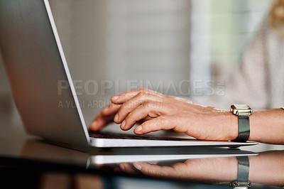 Buy stock photo Cropped shot of an unrecognizable senior businesswoman using a laptop while working from home