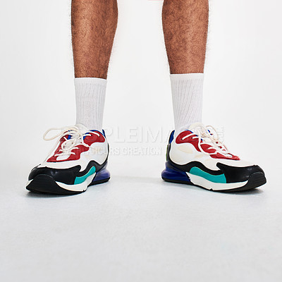 Buy stock photo Low angle shot of an unrecognizable person's shoes while standing against a grey background inside of a studio
