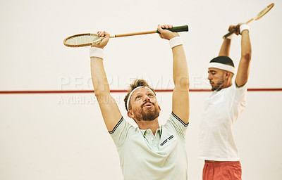 Buy stock photo Shot of two young men stretching before playing a game of squash