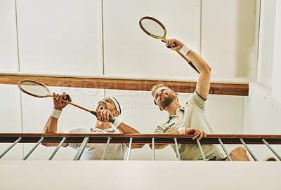 Buy stock photo Below, men and watching game at indoor court for training, sports and fitness in support as badminton player. Male people, together and cheerful for wellness, activity and exercise as ready for match