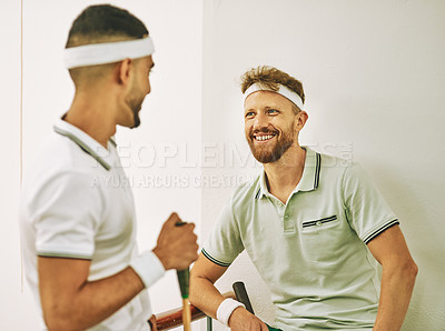 Buy stock photo Shot of two young men chatting after a game of squash on the viewing gallery
