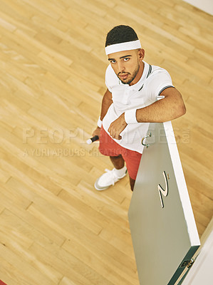 Buy stock photo Above, squash and man in portrait for sport, exercise and training for competition challenge by door. Male person, athlete and racket in court for game match, serving and ready for tournament indoor