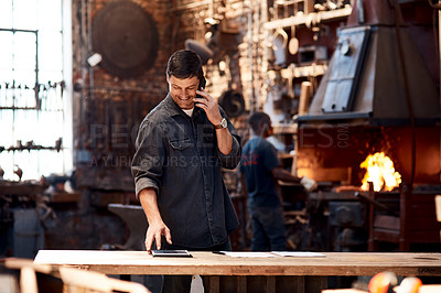 Buy stock photo Cropped shot of a handsome young businessman making a   while working inside his workshop