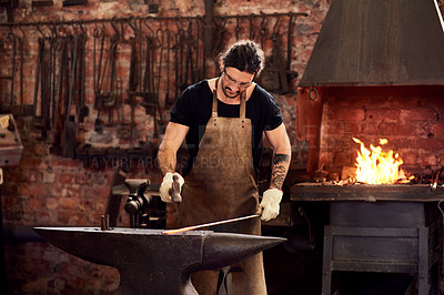 Buy stock photo Worker, blacksmith and metal forge in workshop and manual working on hot steel with hammer, fire and sparks. Man, welding job or iron tools manufacturing and expert, trade and dark workspace