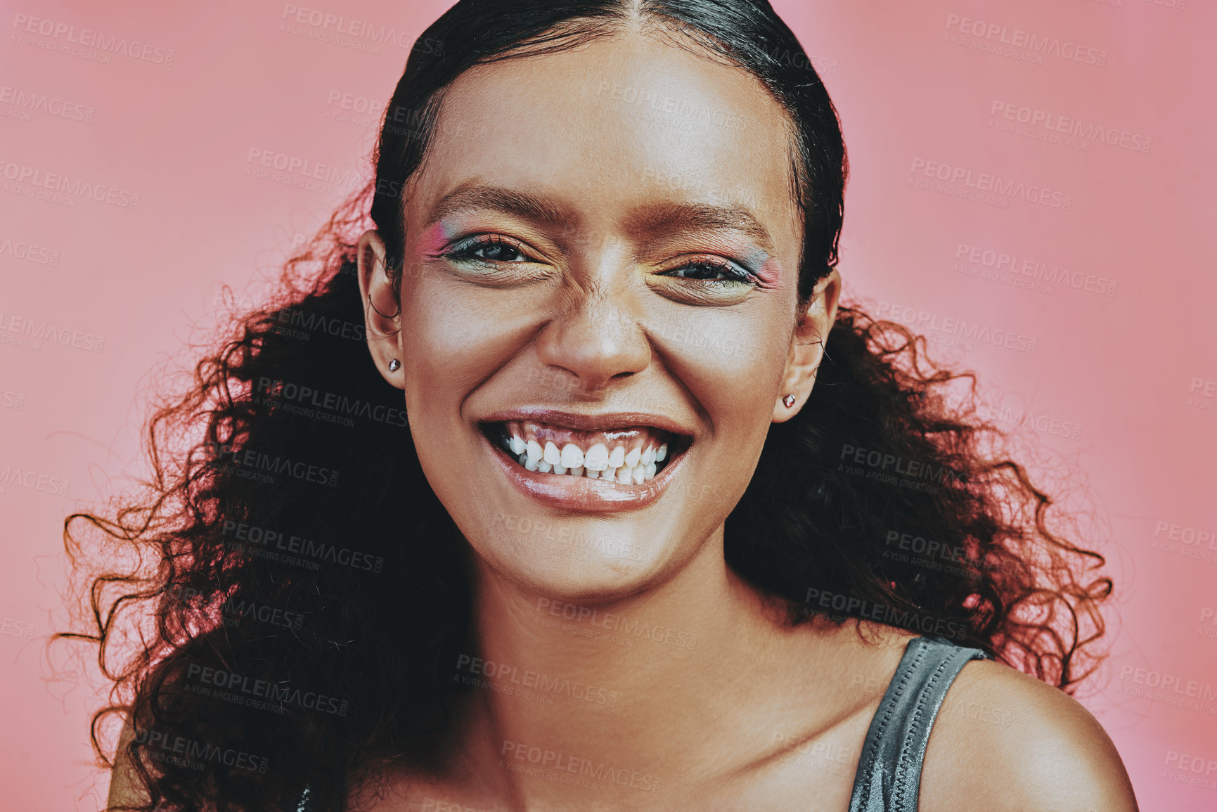 Buy stock photo Shot of a beautiful young woman wearing makeup while posing against a pink background