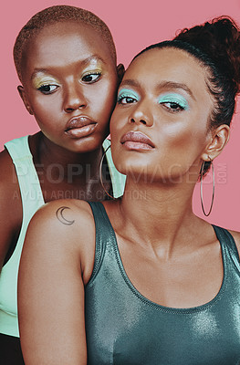 Buy stock photo Shot of two beautiful young women posing together against a pink background