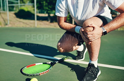 Buy stock photo Closeup shot of an unrecognisable man holding his knee in pain while playing tennis on a tennis court