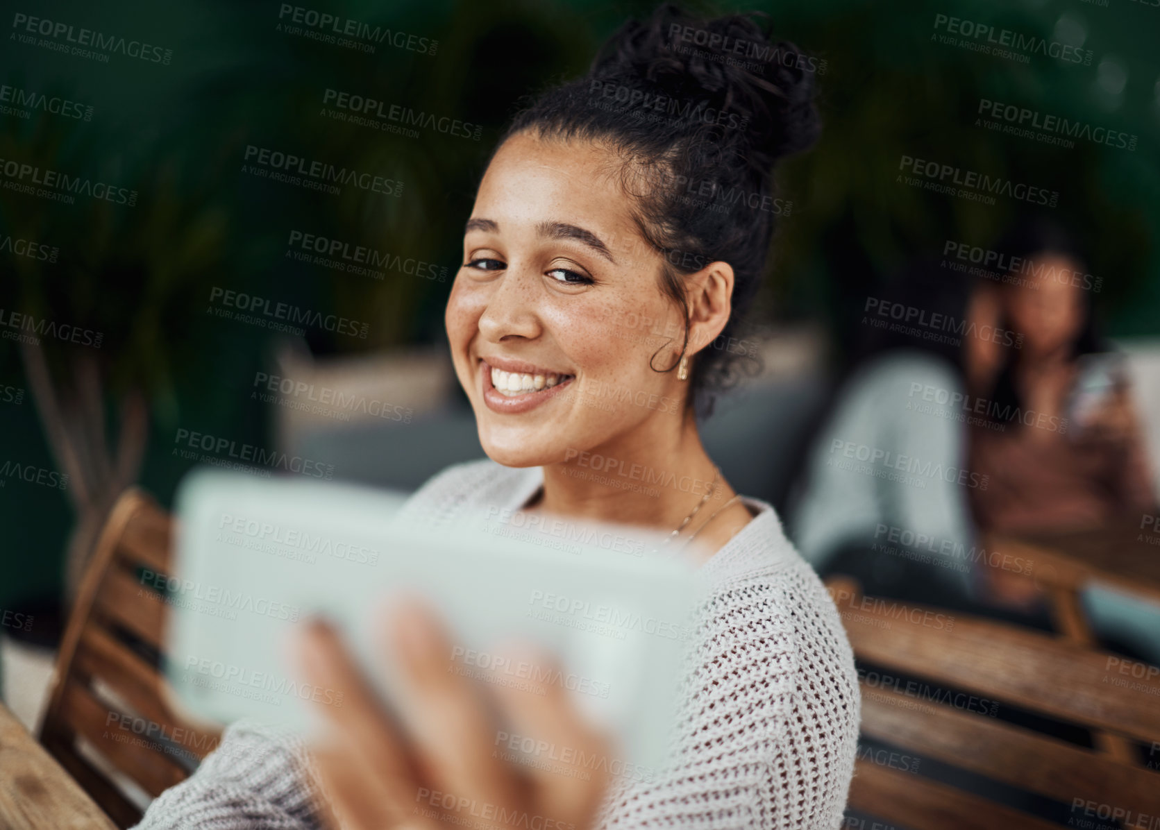Buy stock photo Shot of a beautiful young woman taking selfies at a cafe