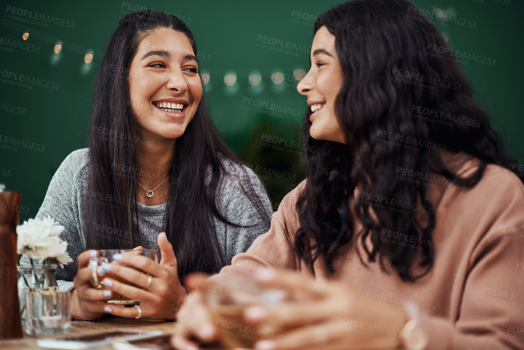 Buy stock photo Shot of young sisters spending quality time at a cafe