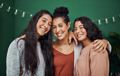 Buy stock photo Shot of three happy young sisters embracing at a cafe
