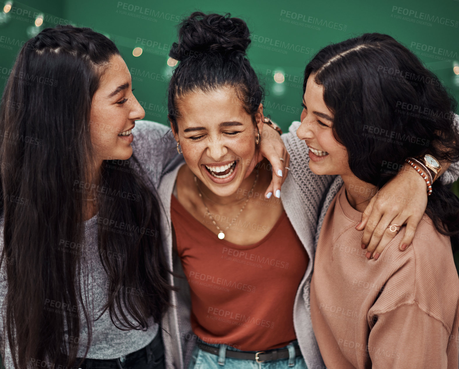 Buy stock photo Shot of three happy young sisters embracing at a cafe