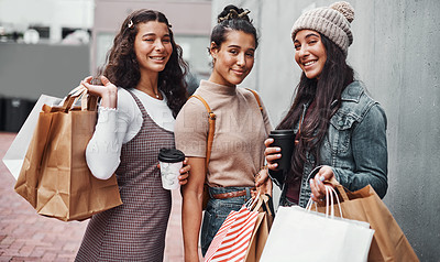 Buy stock photo Cropped portrait of an attractive group of sisters bonding together during a shopping spree in the city