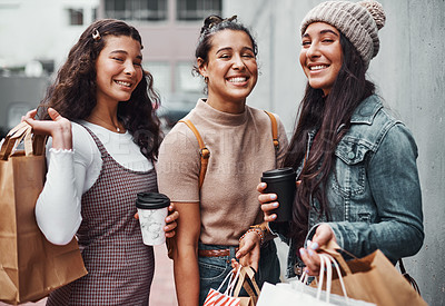 Buy stock photo Cropped portrait of an attractive group of sisters bonding together during a shopping spree in the city