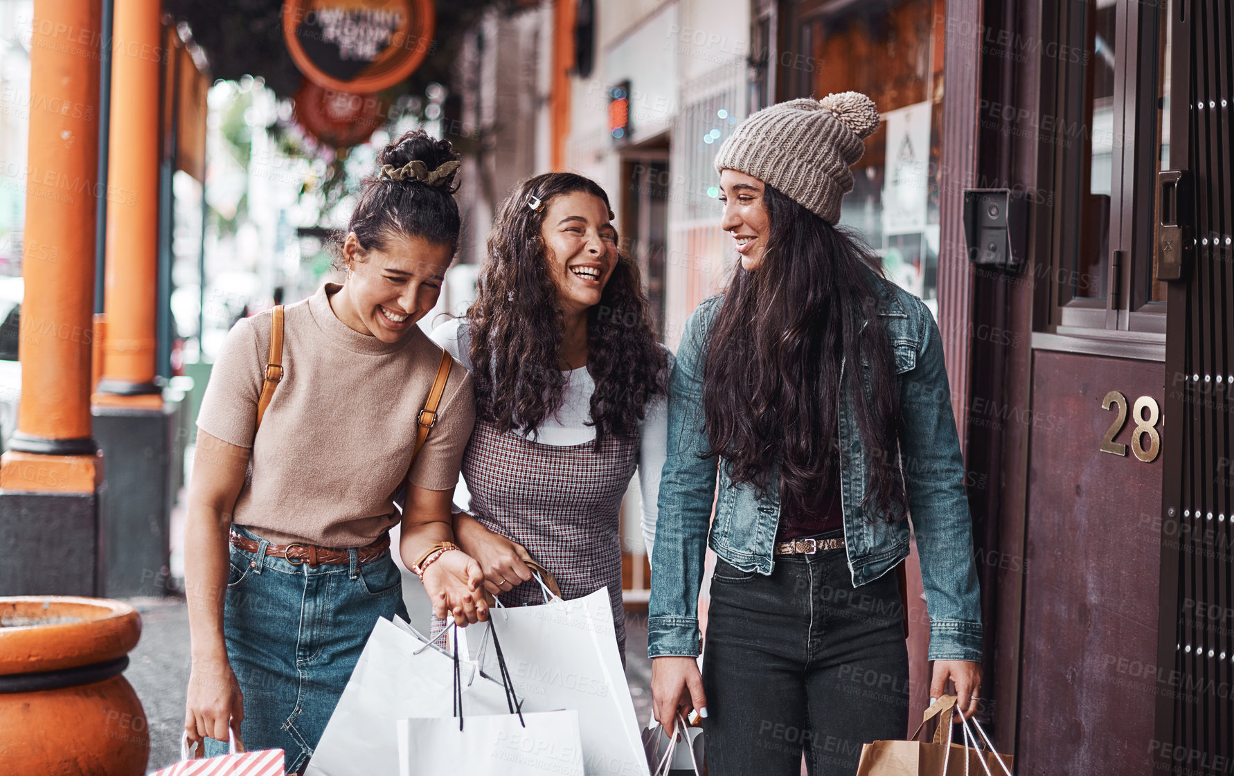 Buy stock photo Cropped shot of an attractive group of sisters bonding together during a shopping spree in the city
