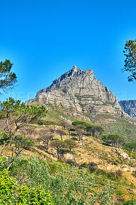Buy stock photo Low angle view of Table Mountain in South Africa against a blue sky with copy space. Scenic nature landscape of a remote rocky hiking trail and travel location to explore in Cape Town